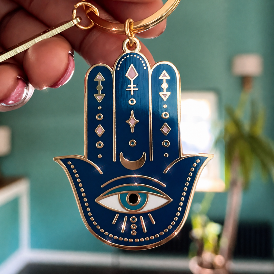HAMSA DOUBLE-SIDED ENAMEL KEYCHAIN IN GOLD, BLUE & WHITE